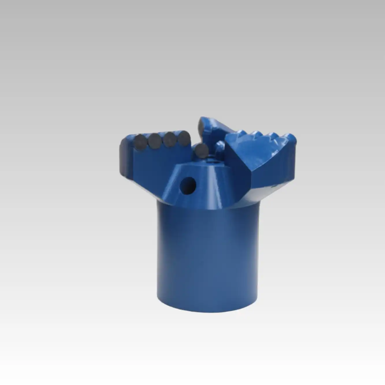 How do three-blade oil drill bits reduce friction?